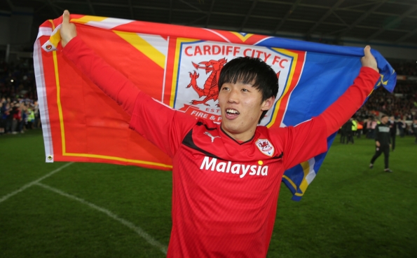 Promotion party: Kim played his part in Cardiff's promotion last season [Photo: Nick Potts/ AP]